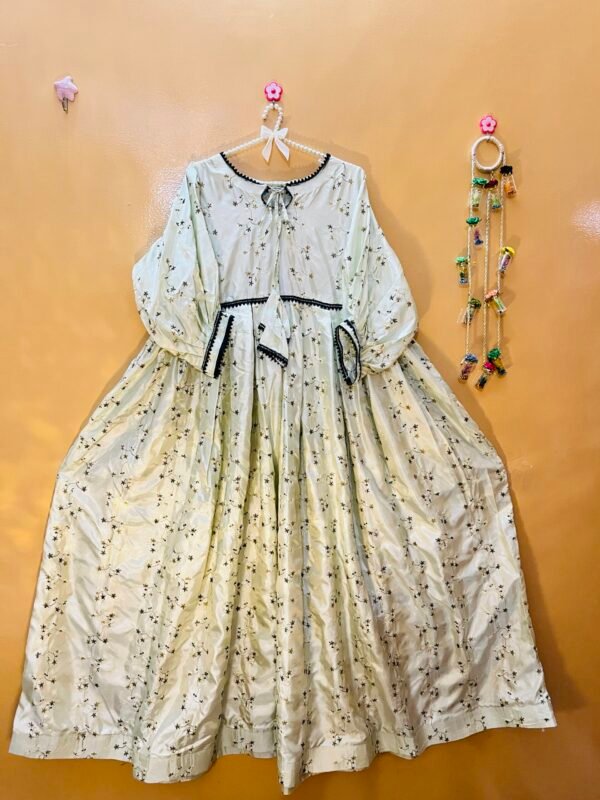 Silk long frock with embroidered work, lace details, and three-quarter sleeves